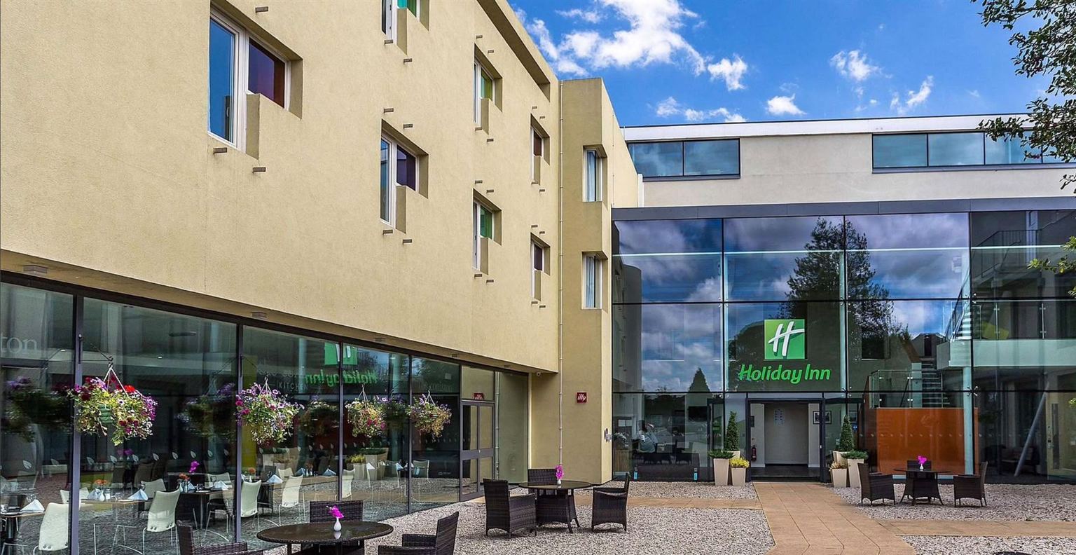 The courtyard at Coniston Hotel in Sittingbourne: outdoor tables in front of the glass-fronted restaurant and the hotel entrance.