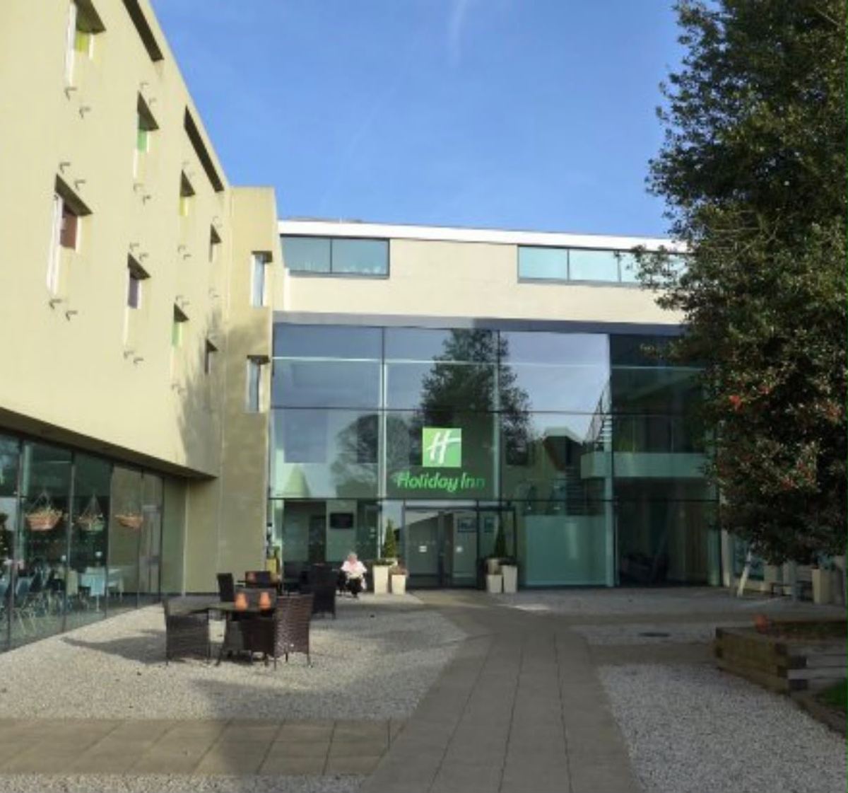 The glass entrance to Coniston Hotel, Sittingbourne, seen across the courtyard.